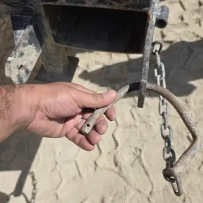 Bent mild-steel rod pin from competitor manbasket showing failure of weak retention system.