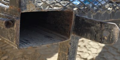 Integrated Fork Guide 7 | ManBaskets.ca Broken flat bar fork pocket guide on competitor telehandler basket showing cracked welds and unsafe design failure.