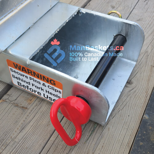 ManBaskets.ca Integrated Fork Guide with high-grade retaining pin and welded fork pocket showing proper telehandler safety design.
